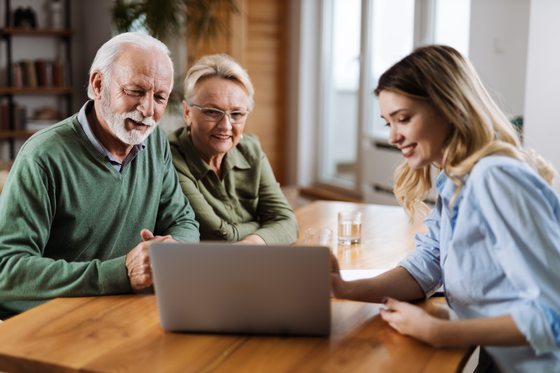 Senior couple having a meeting with insurance agent at home